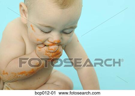 Infant eating baby food with fingers. View Large Photo Image Stock Image - Infant eating baby food with fingers.. Fotosearch