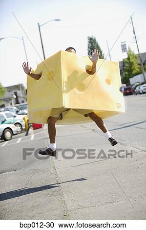 Man in a cheese costume leaping in the air. View Large Photo Image Stock Image - Man in a cheese costume leaping in the air. . Fotosearch