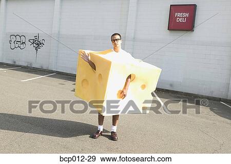Stock Photo - Man on the street wearing a cheese costume. . Fotosearch