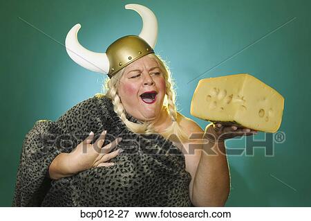 Stock Photo - Viking woman holding a huge brick of cheese.. Fotosearch