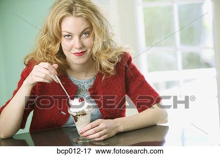 Woman eating a chocolate sundae. View Large Photo Image Stock Photo - Woman eating a chocolate sundae.. Fotosearch