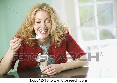 Woman eating a chocolate sundae. View Large Photo Image Stock Photo - Woman eating a chocolate sundae.. Fotosearch