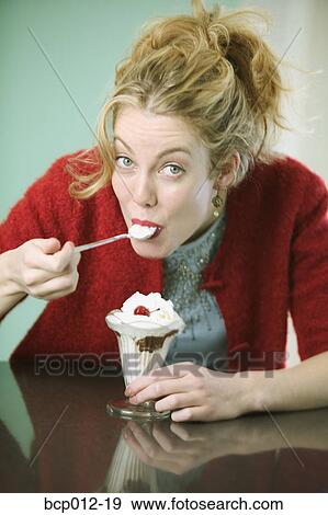 Woman eating a chocolate sundae. View Large Photo Image Stock Photo - Woman eating a chocolate sundae.. Fotosearch