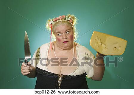Woman holding a knife and a big block of cheese. View Large Photo Image Stock Photograph - Woman holding a knife and a big block of cheese. . Fotosearch