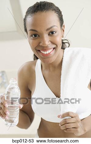 Woman in workout clothes holding a water bottle. View Large Photo Image Stock Image - Woman in workout clothes holding a water bottle. . Fotosearch
