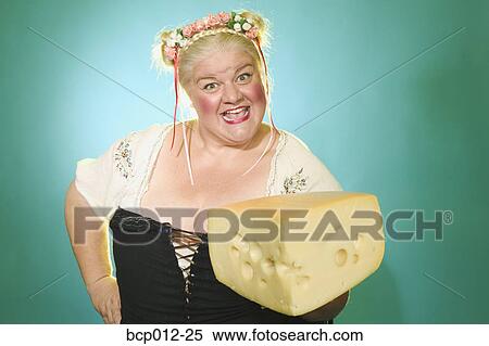 Stock Photography - Woman offering a big brick of cheese. . Fotosearch