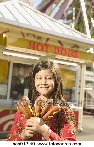 Young teen girl holding corndogs. View Large Photo Image Stock Image - Young teen girl holding corndogs.. Fotosearch