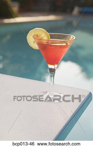Stock Photograph - A cocktail on a diving board. . Fotosearch