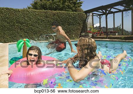 A group of teenage kids playing in a pool. View Large Photo Image Stock Photograph - A group of teenage kids playing in a pool. . Fotosearch