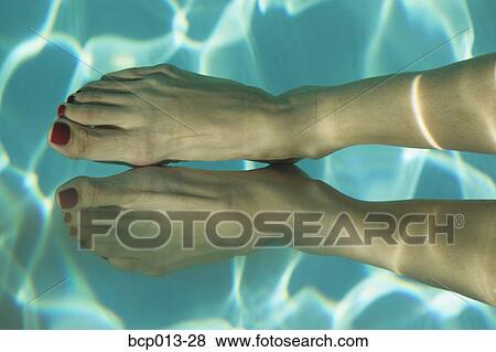 A pair of feet, with red nail polish, underwater. View Large Photo Image Stock Photo - A pair of feet, with red nail polish, underwater.. Fotosearch