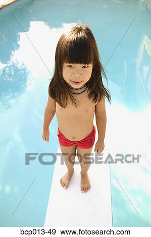 Stock Photo - A young girl on a diving board. . Fotosearch