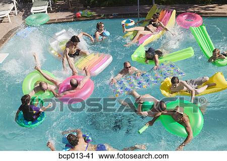Stock Image - Overhead view of a pool party.. Fotosearch