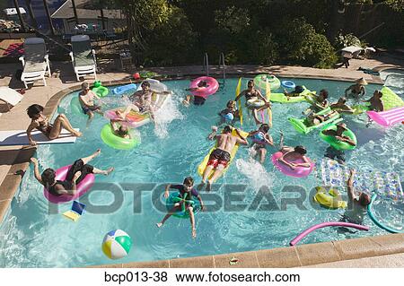 Stock Photo - Overhead view of a pool party.. Fotosearch