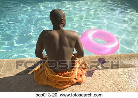 Rear view of a man sitting at poolside. View Large Photo Image Stock Image - Rear view of a man sitting at poolside.. Fotosearch