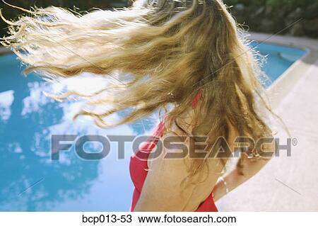 Woman tossing her hair at poolside. View Large Photo Image Stock Image - Woman tossing her hair at poolside.. Fotosearch