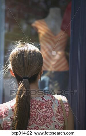 A woman admiring clothing in a window. View Large Photo Image Stock Image - A woman admiring clothing in a window.. Fotosearch