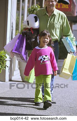 A young girl shopping with her father. View Large Photo Image Stock Image - A young girl shopping with her father.. Fotosearch