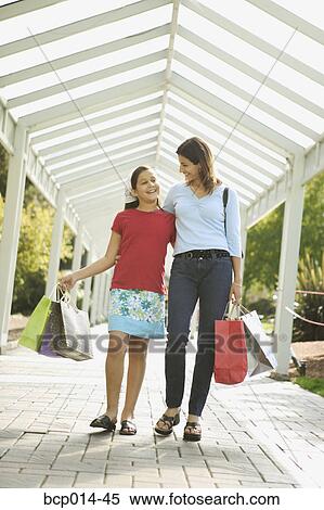Mother and daughter strolling in a shopping arcade. View Large Photo Image Stock Photography - Mother and daughter strolling in a shopping arcade.. Fotosearch