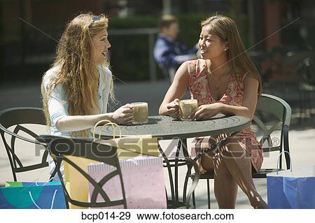 Two friends taking a coffee break after shopping. View Large Photo Image Stock Photo - Two friends taking a coffee break after shopping.. Fotosearch