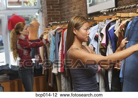 Two women shopping in a trendy boutique. View Large Photo Image Stock Image - Two women shopping in a trendy boutique. . Fotosearch