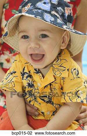 A baby boy in bright clothes and hat. View Large Photo Image Stock Image - A baby boy in bright clothes and hat.. Fotosearch