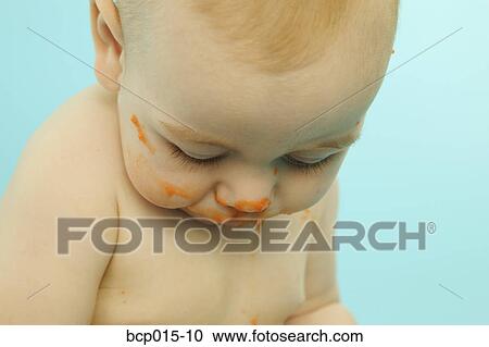 A baby with his face smeared with baby food. View Large Photo Image Stock Image - A baby with his face smeared with baby food.. Fotosearch