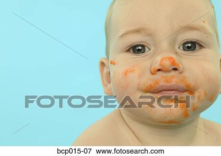 A baby with his face smeared with baby food. View Large Photo Image Stock Photo - A baby with his face smeared with baby food.. Fotosearch