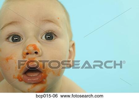 A baby with his face smeared with baby food. View Large Photo Image Stock Photograph - A baby with his face smeared with baby food.. Fotosearch