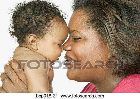 A mom snuggling with her baby girl. View Large Photo Image Stock Image - A mom snuggling with her baby girl.. Fotosearch