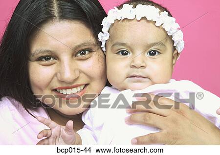 A young mother and her baby daughter. View Large Photo Image Picture - A young mother and her baby daughter.. Fotosearch