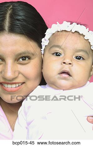 A young mother and her baby daughter. View Large Photo Image Stock Photography - A young mother and her baby daughter.. Fotosearch