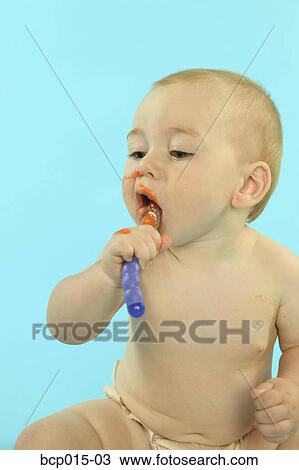 Baby boy holding a spoon in his mouth. View Large Photo Image Stock Image - Baby boy holding a spoon in his mouth.. Fotosearch