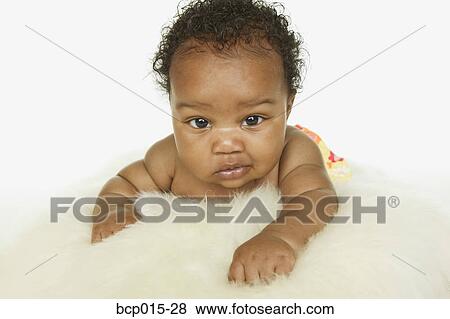 Baby girl crawling on a white fur rug. View Large Photo Image Stock Photo - Baby girl crawling on a white fur rug. . Fotosearch