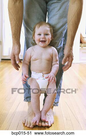 Baby girl standing on father's bare feet. View Large Photo Image Stock Image - Baby girl standing on father's bare feet.. Fotosearch