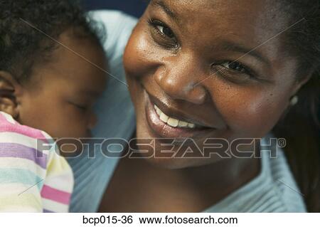 Close-up of a mother holding her baby girl close. View Large Photo Image Stock Photograph - Close-up of a mother holding her baby girl close. . Fotosearch