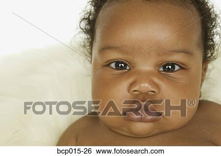 Stock Photograph - Close-up portrait of a baby girl. . Fotosearch