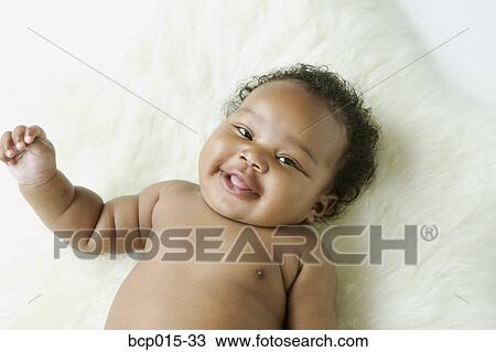 Overhead view of a baby girl on a white fur rug. View Large Photo Image Stock Image - Overhead view of a baby girl on a white fur rug. . Fotosearch