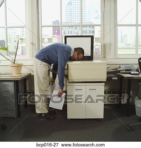 A man with his head in a copy machine. View Large Photo Image Stock Photo - A man with his head in a copy machine.. Fotosearch