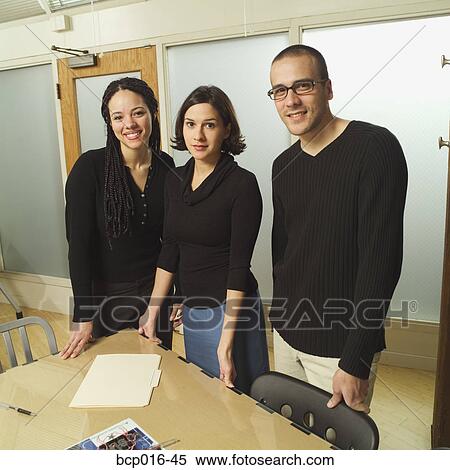 Stock Photography - A trio of young office colleagues. . Fotosearch