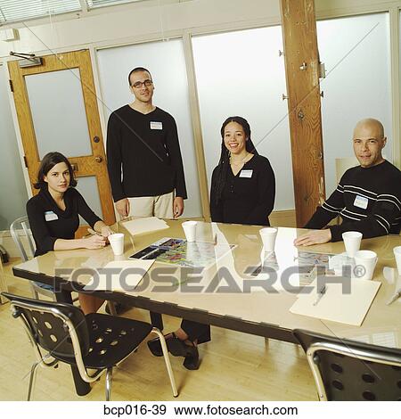 Stock Photo - Business colleagues meeting at a conference table.. Fotosearch