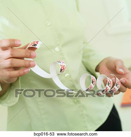 Close-up of hands unrolling stamps. View Large Photo Image Stock Image - Close-up of hands unrolling stamps.. Fotosearch
