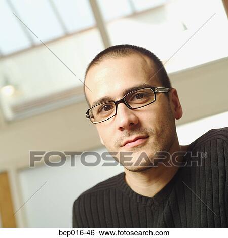Stock Photograph - Close-up office portrait of a young man. . Fotosearch
