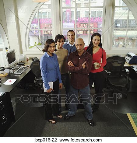 Stock Image - Five young business colleagues in their office.. Fotosearch