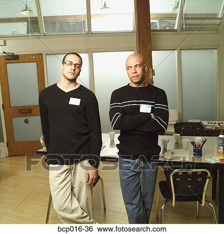 Male colleagues leaning on a conference room table. View Large Photo Image Stock Photograph - Male colleagues leaning on a conference room table.. Fotosearch
