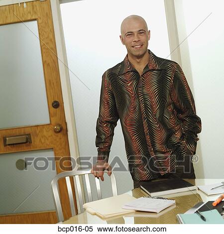 Man standing by a conference room table. View Large Photo Image Stock Photography - Man standing by a conference room table.. Fotosearch