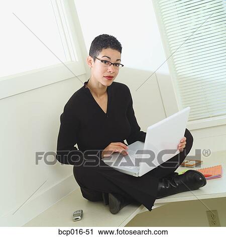 Office portrait of a woman working on a laptop. View Large Photo Image Stock Image - Office portrait of a woman working on a laptop.. Fotosearch