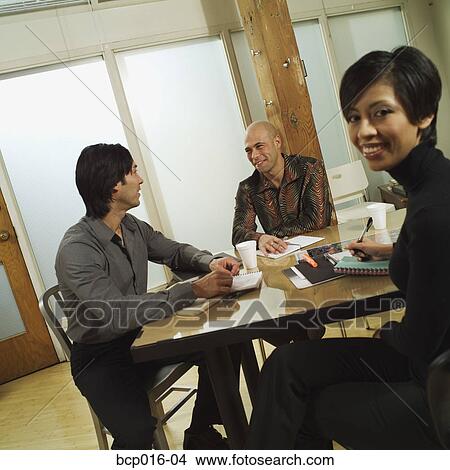 Picture - Three business colleagues in a conference room.. Fotosearch