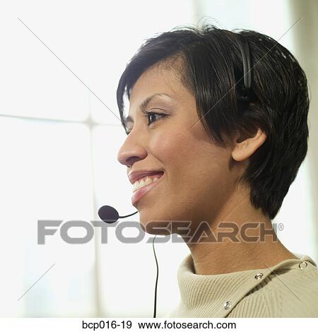 Woman wearing a telephone headset. View Large Photo Image Stock Photo - Woman wearing a telephone headset.. Fotosearch