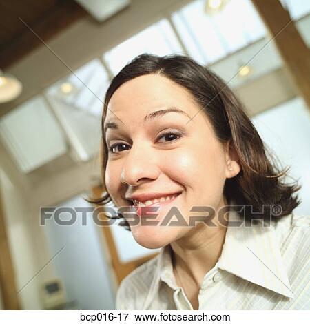 Stock Photo - Young woman smiling in an office.. Fotosearch