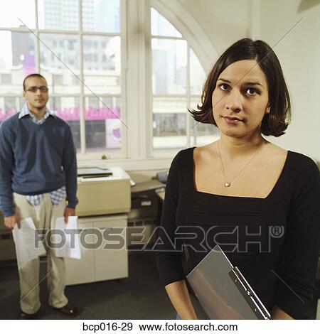 Young woman worshiped from afar by office nerd. View Large Photo Image Stock Photo - Young woman worshiped from afar by office nerd.. Fotosearch